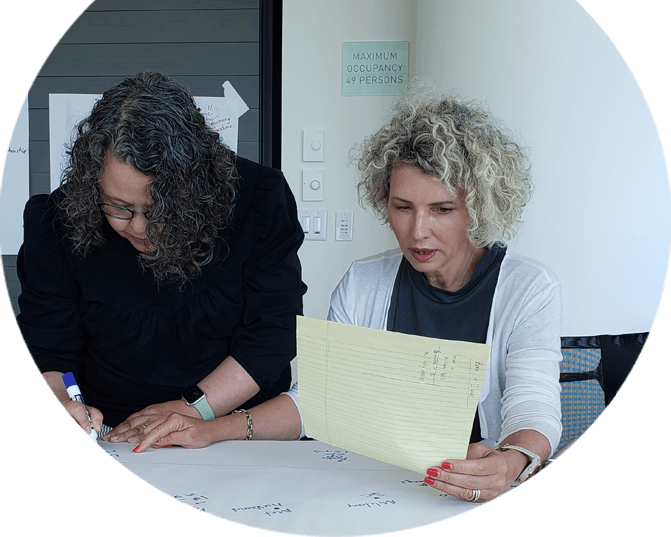 Two ladies working together.